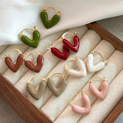 Green heart hoop earrings with gold-tone hooks, glossy sculpted heart design.