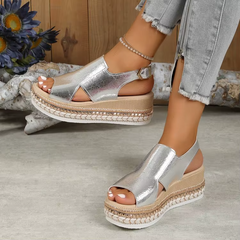 Silver metallic platform sandals with open toe, ankle strap, and jute-style midsole trim