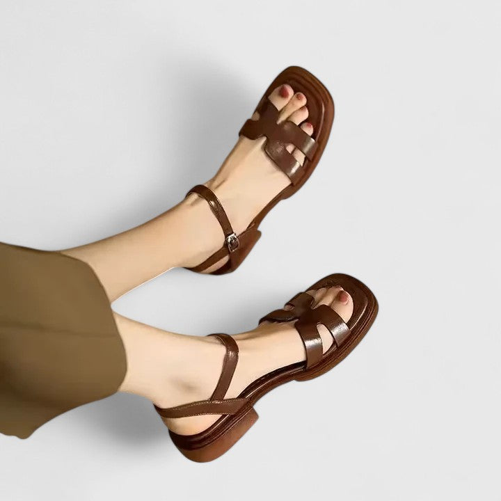 Brown flat sandals with brown straps and ankle buckle