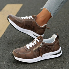 Brown zip-up comfort sneakers, lace-up front with metal zipper and white midsole