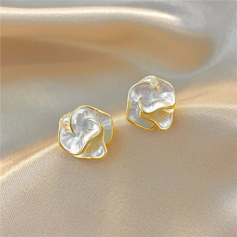 Gold-tone flower pearl stud earrings with white petal centers