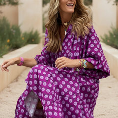 Bohemian dress in purple with white floral print, flowing maxi length, wide sleeve style