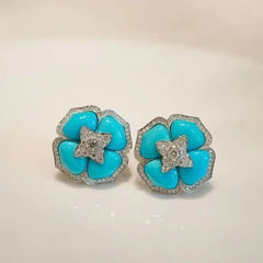Turquoise flower stud earrings with silver-tone crystal center and halo edging