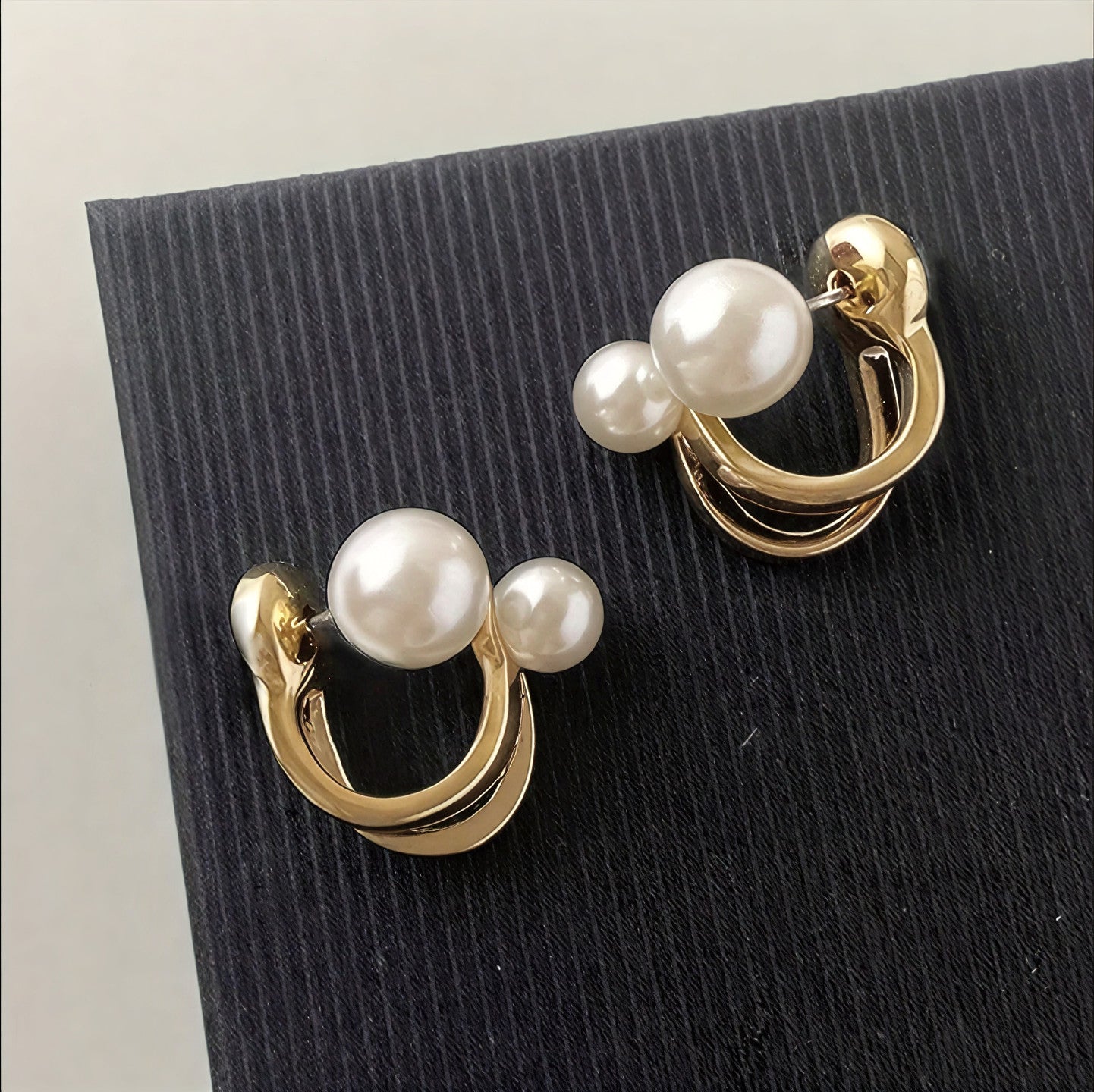 Twisted pearl statement earrings, gold-tone hoops with three white pearls