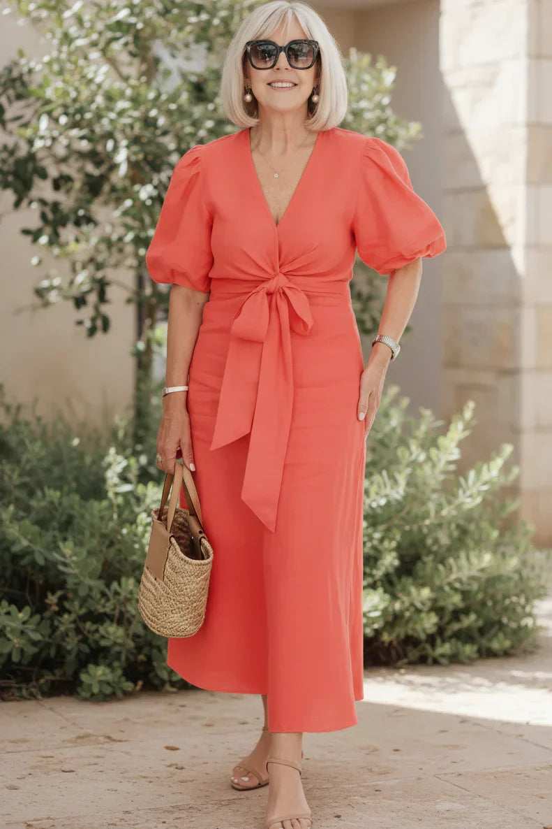 V-neck midi dress in vivid red with puff sleeves and tied waist.