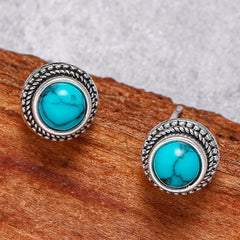 Turquoise stud earrings with circular rope-textured silver border