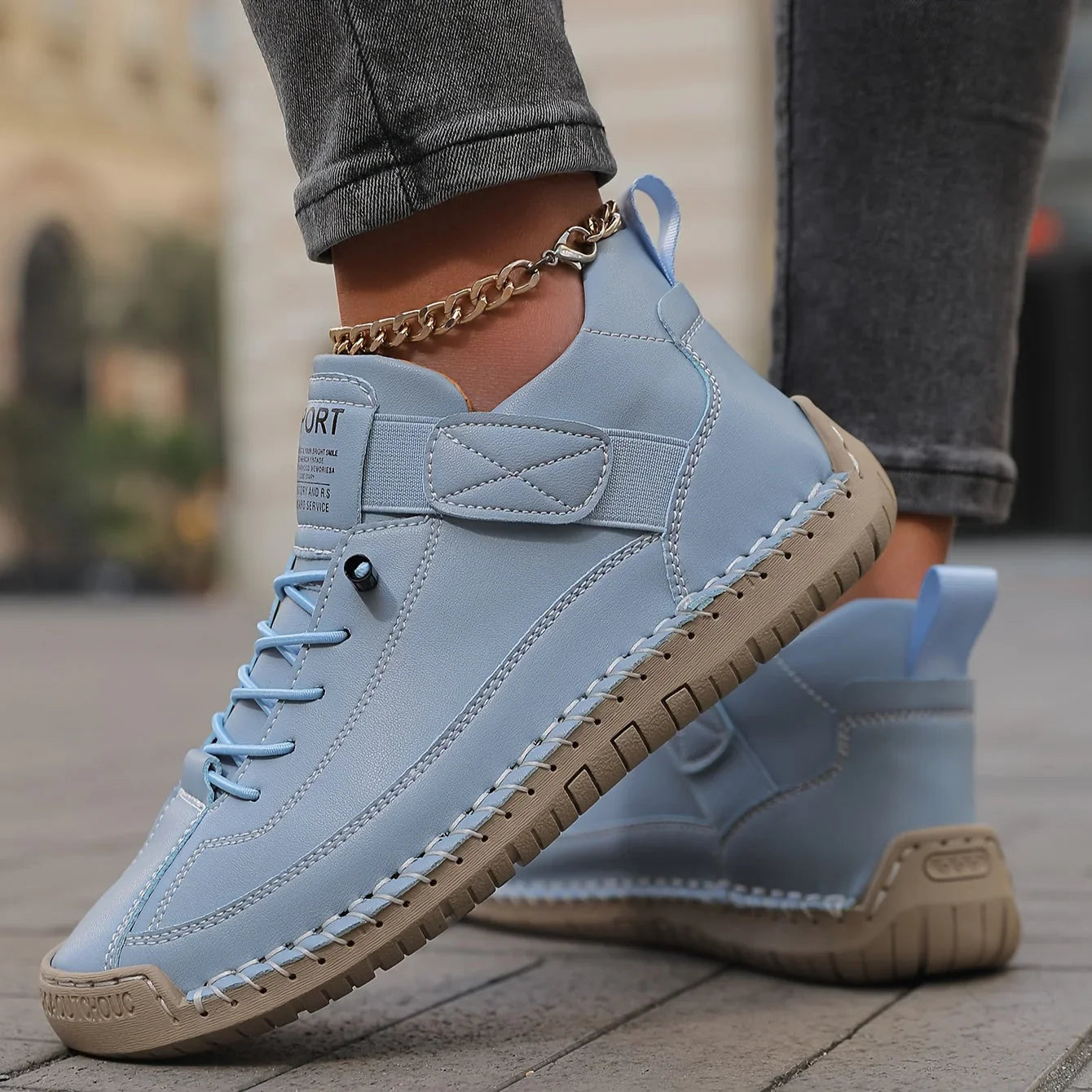 Light blue comfort sneakers with lace-up front, padded collar, and chain ankle strap