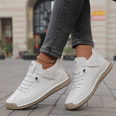 White comfort sneakers with lace-up design and chain ankle strap for everyday wear