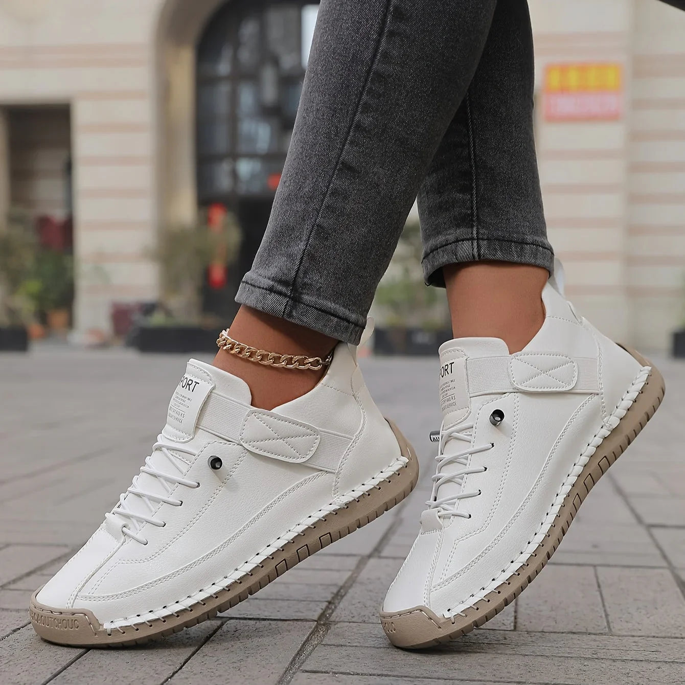 White comfort sneakers with lace-up design and chain ankle strap for everyday wear