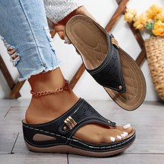 Navy Jean sandals with perforated leather-look panels and gold-tone buckle strap.