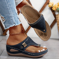 Navy Jean sandals with perforated upper and gold-tone buckle, flat comfort sole.