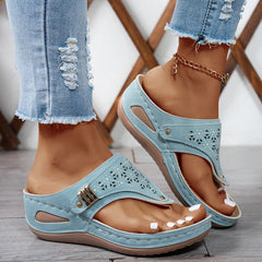 Light blue Jean sandals with cutout perforations and adjustable buckle on a comfort footbed.
