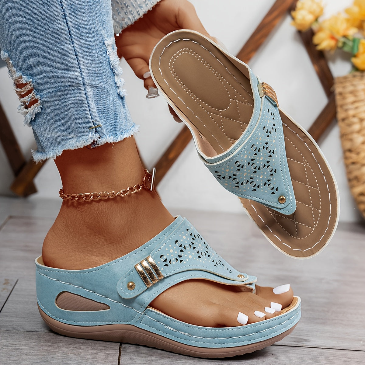 Light blue Jean sandals with perforated strap, gold-tone buckle, and cushioned sole.
