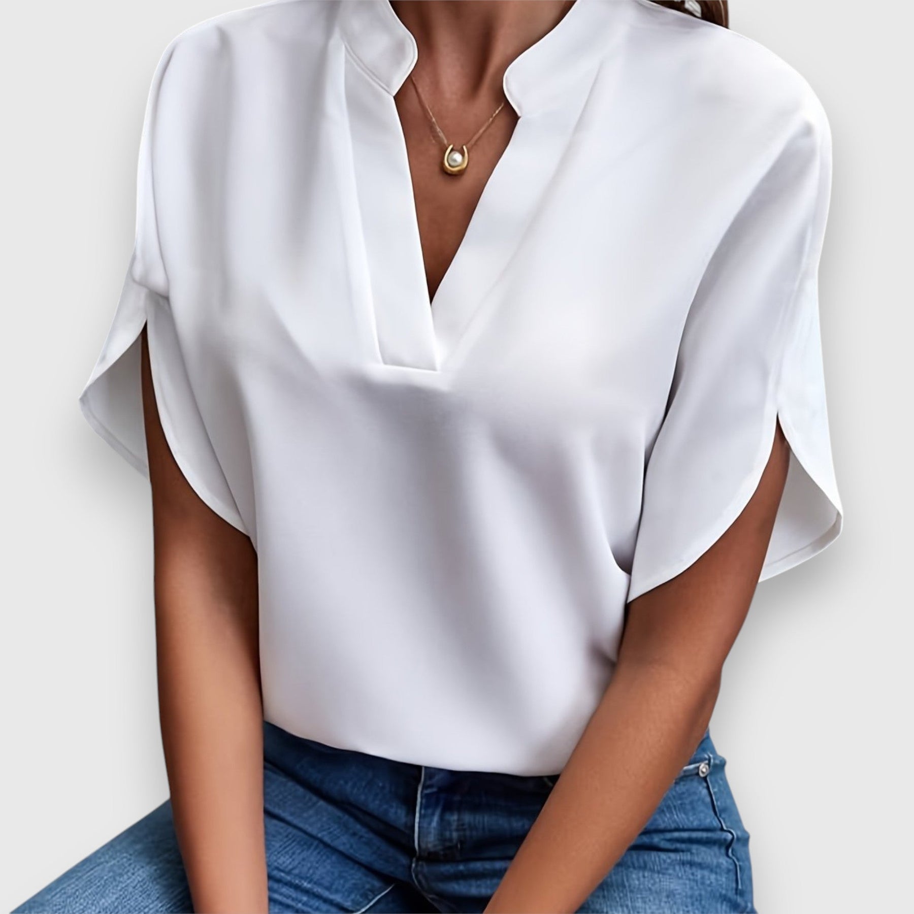 White V-neck short-sleeve blouse with draped sleeves and relaxed fit