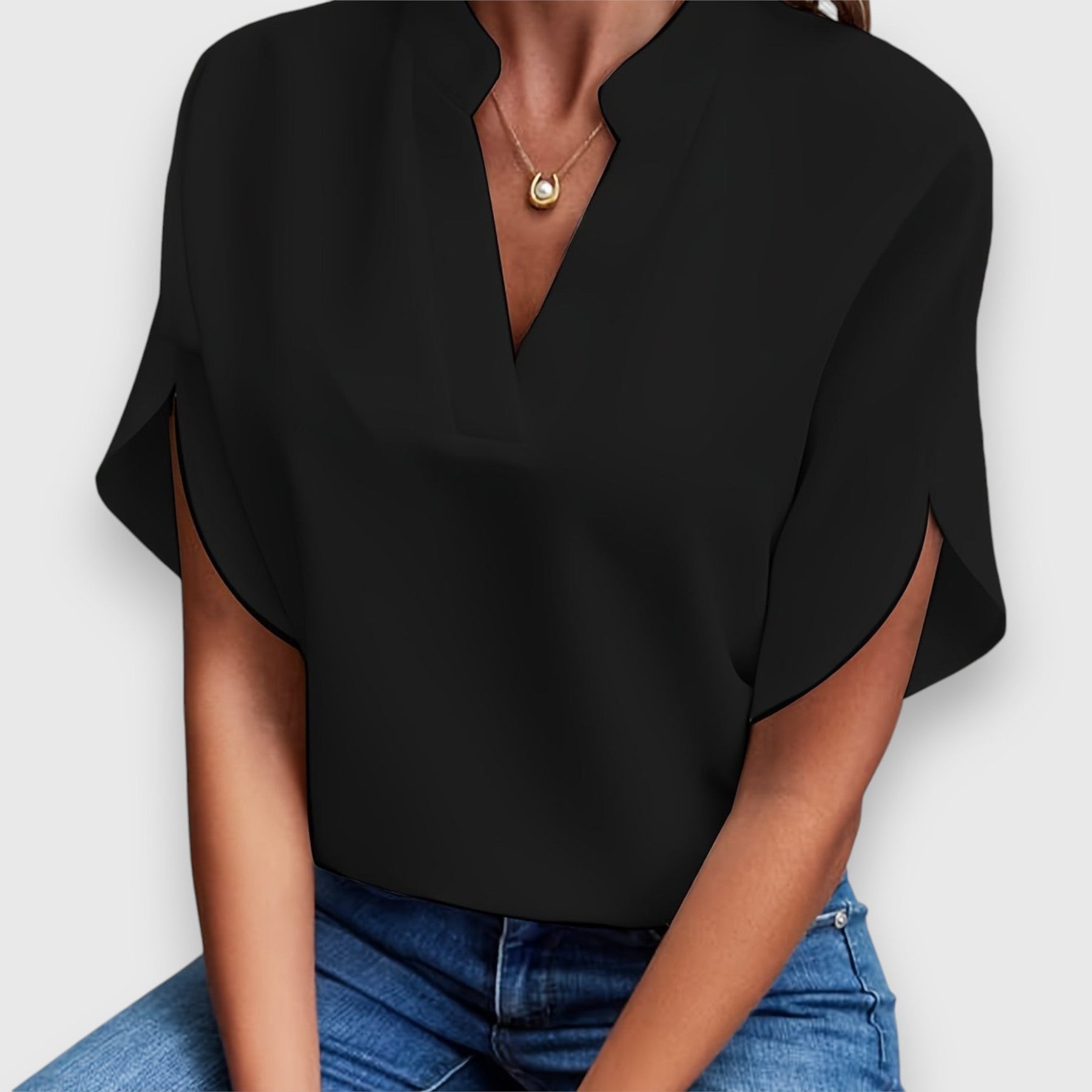 Black V-neck short-sleeve blouse with draped sleeves and relaxed fit