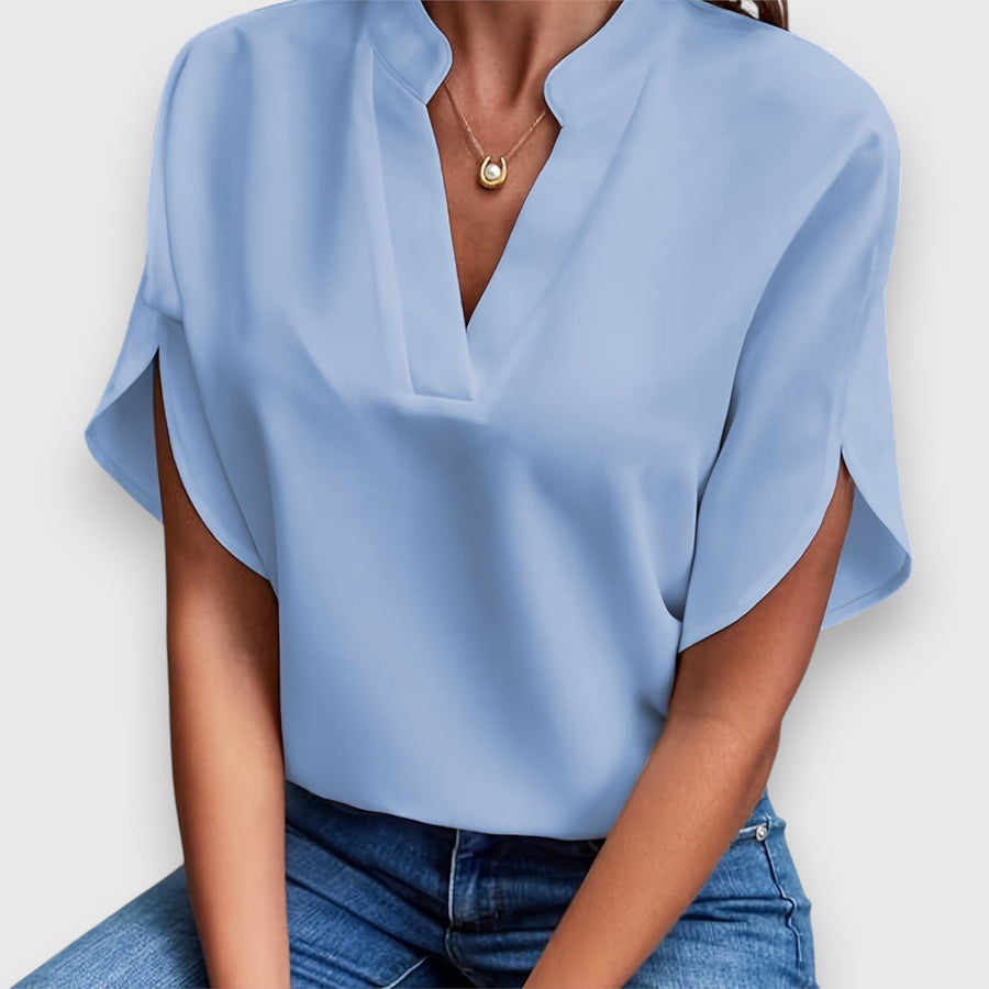 Blue V-neck short-sleeve blouse with draped sleeves and relaxed fit
