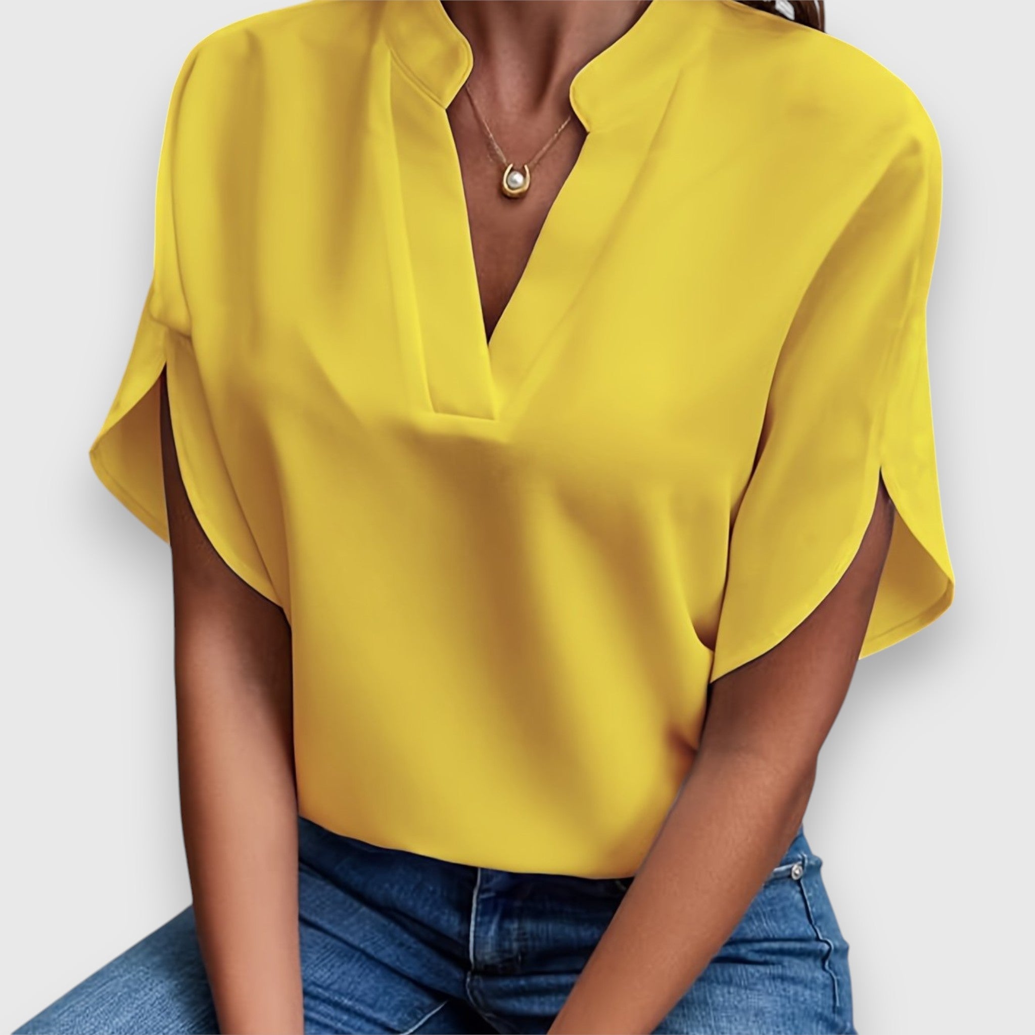 Yellow V-neck short-sleeve blouse with draped sleeves and relaxed fit