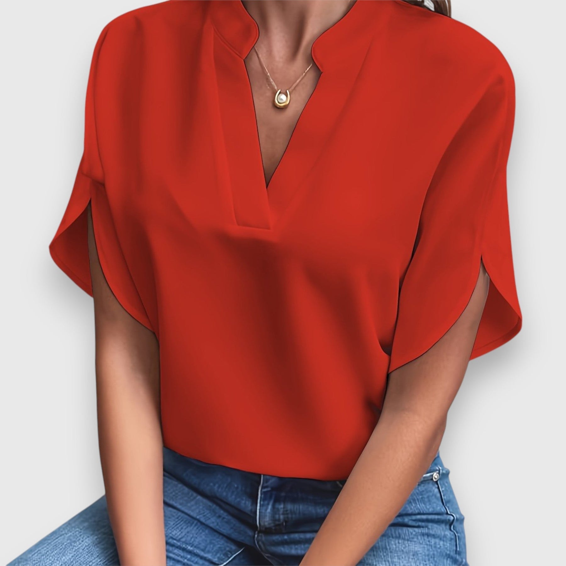 Red V-neck short-sleeve blouse with draped sleeves and relaxed fit