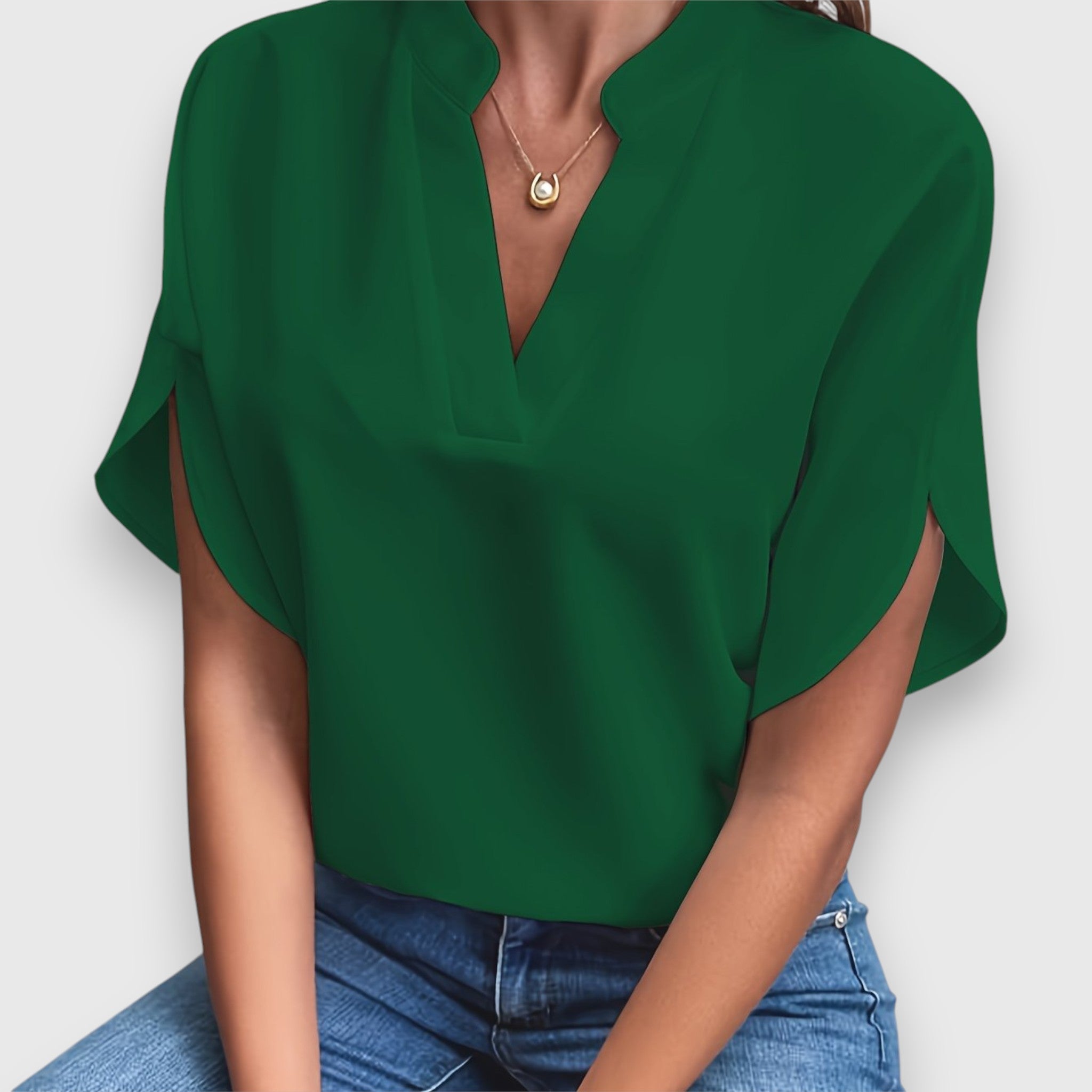 Green V-neck short-sleeve blouse with draped sleeves and relaxed fit