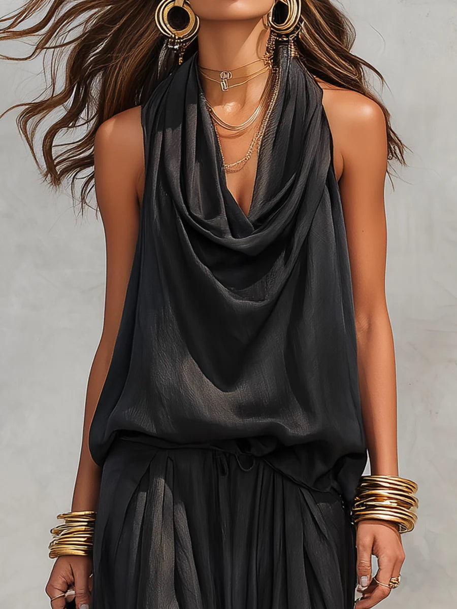 Black sleeveless draped cowl-neck top with gathered waist and tiered skirt