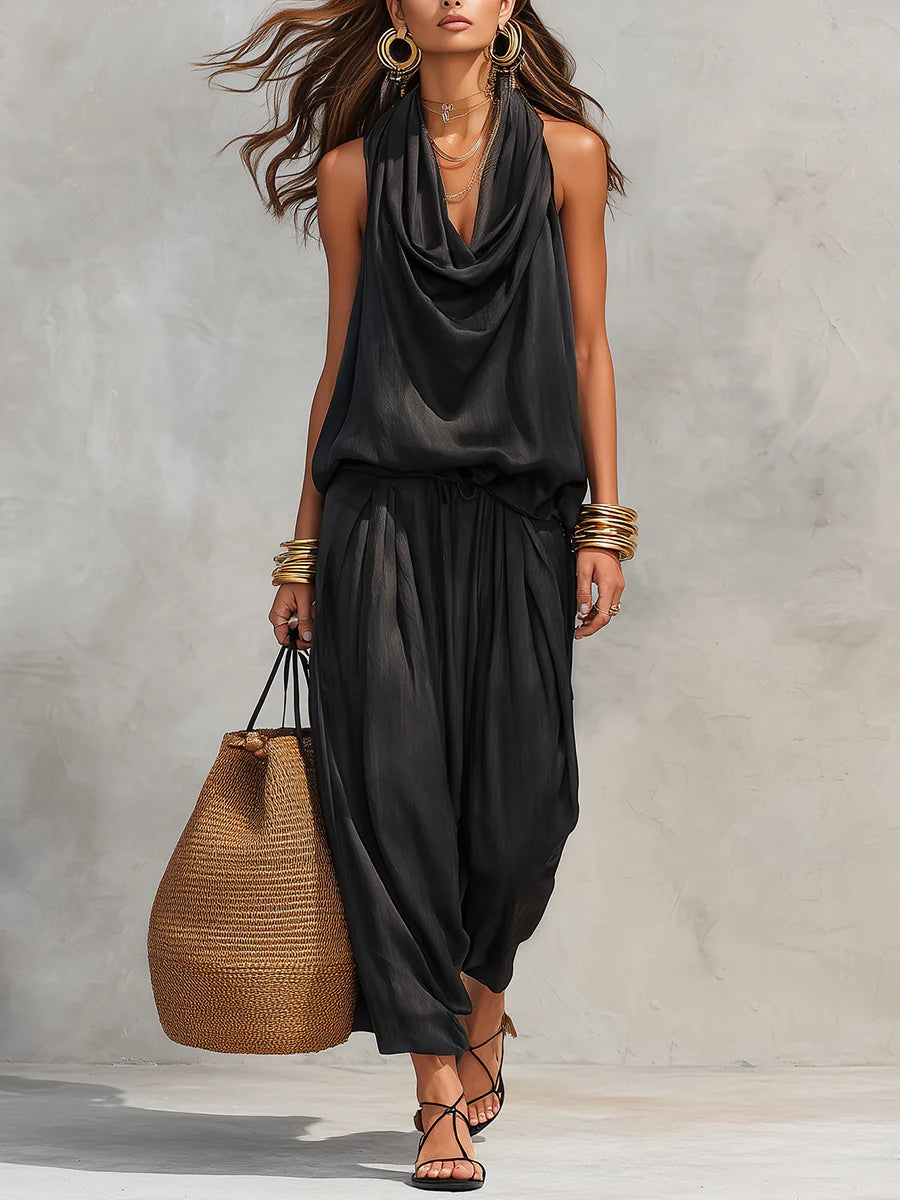 Black two-piece set with sleeveless draped cowl-neck top and gathered maxi skirt