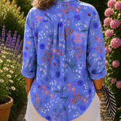 Blue floral button-up blouse, back view with pleated yoke and rolled sleeves