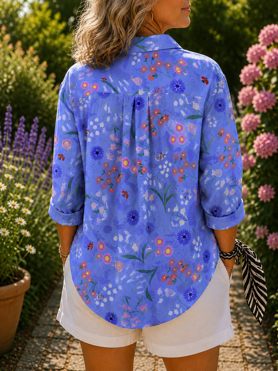 Blue floral button-up blouse, back view with pleated yoke and rolled sleeves