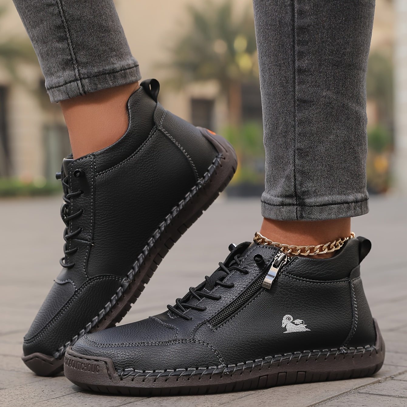 Black zip-up comfort shoes with lace-up front, side zipper tab, and stitched sole