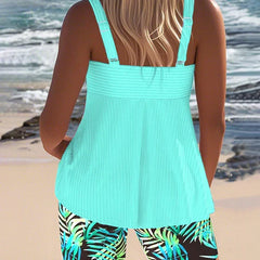 Bright ribbed tankini top and shorts (back view), cyan with tropical leaf print.