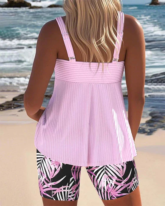 Bright ribbed tankini top and shorts (back view), pink with tropical leaf print.
