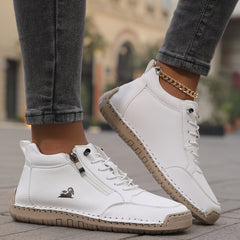 White zip-up comfort shoes with lace-up eyelets, side zipper, and stitched outsole
