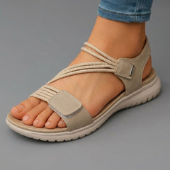 Beige open-toe sandals with braided toe strap, hook-and-loop ankle strap