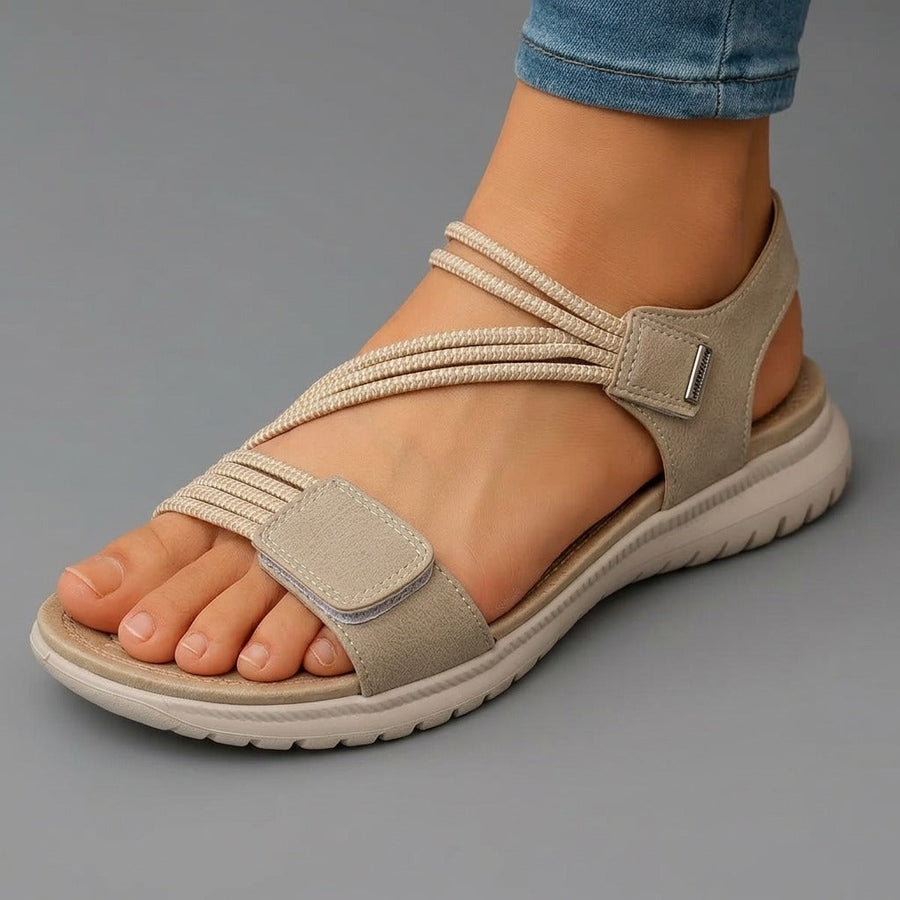 Beige open-toe sandals with braided toe strap, hook-and-loop ankle strap
