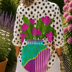 Blooming vase blouse, side view, white polka-dot sleeves and bright floral striped back