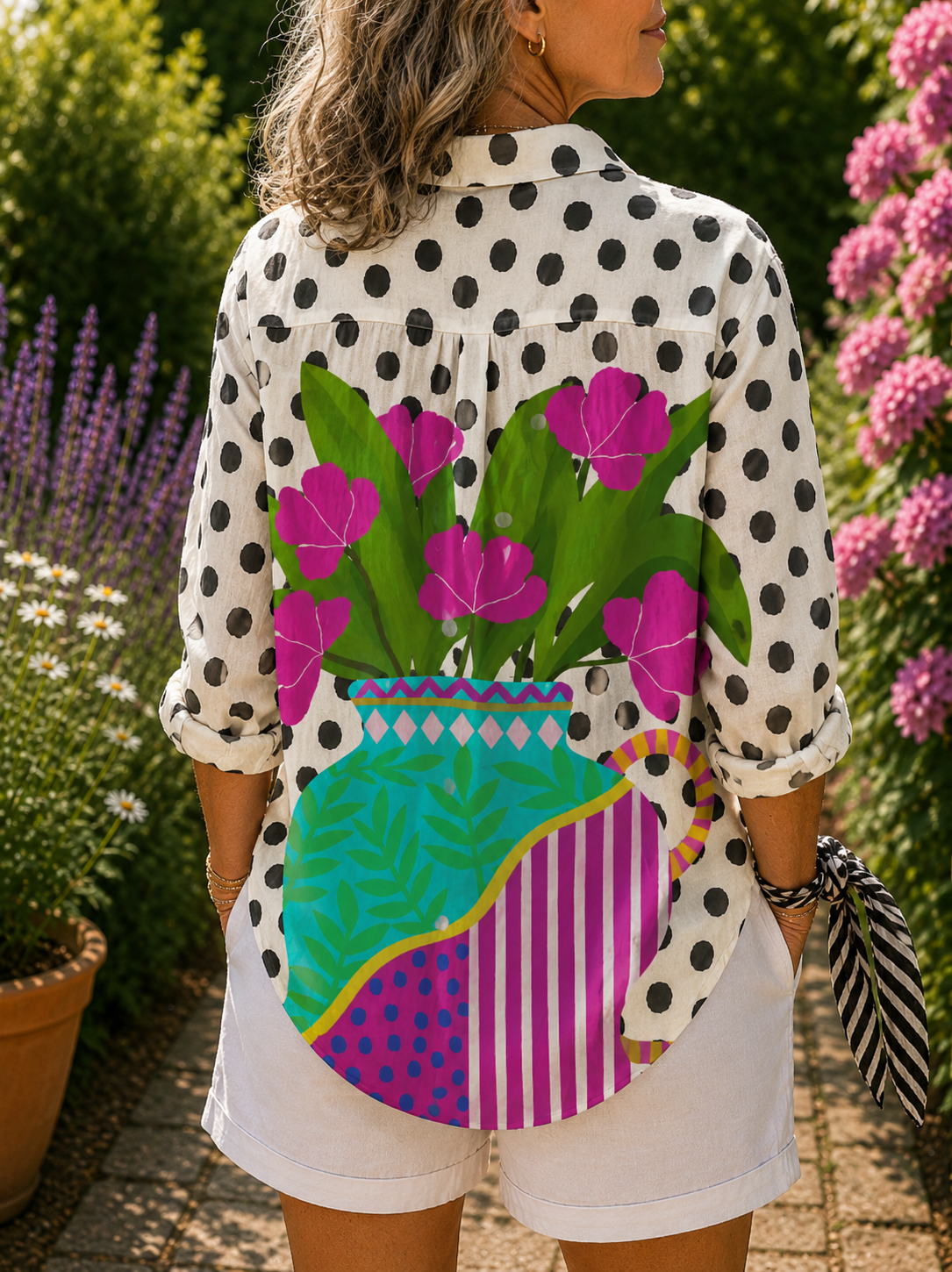 Blooming vase blouse, side view, white polka-dot sleeves and bright floral striped back
