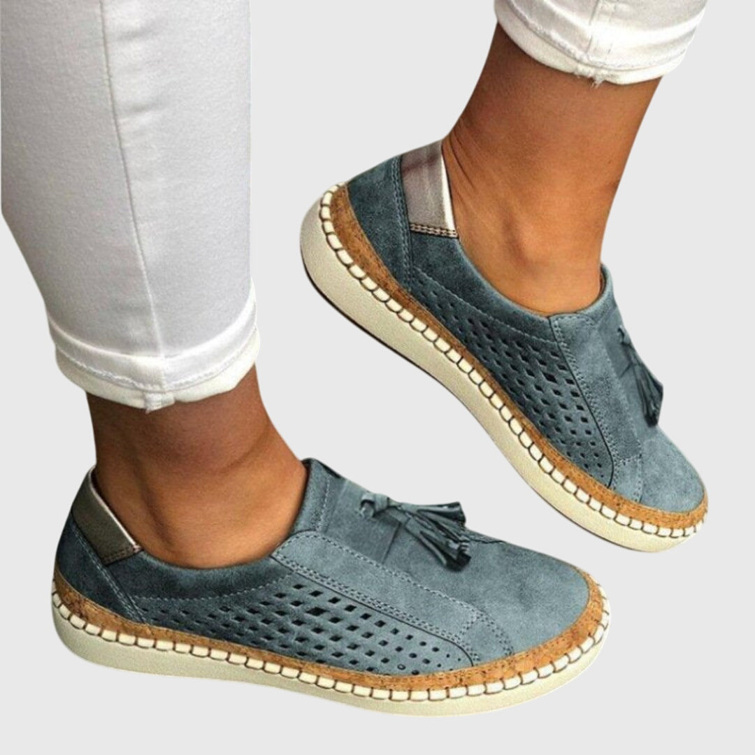 Blue-gray perforated comfort slip-on shoes with tassel detail and tan stitched sole