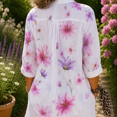 Floral button-up blouse, back view, white with pink/purple flowers, tab sleeves, curved hem