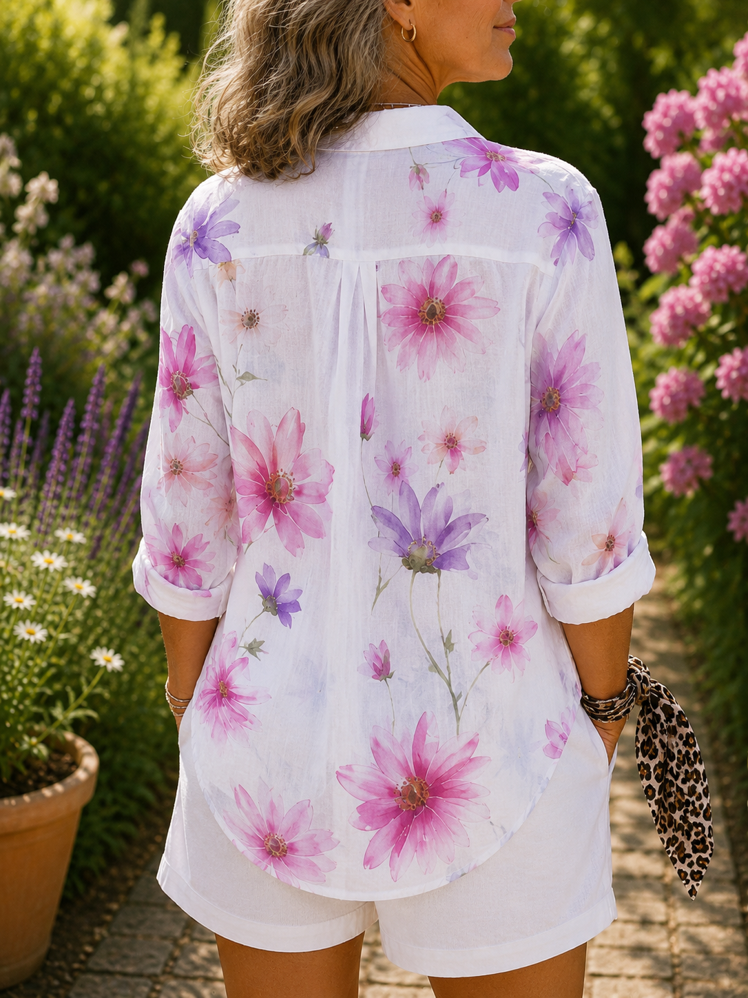 Floral button-up blouse, back view, white with pink/purple flowers, tab sleeves, curved hem