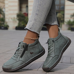 Gray zip-up comfort shoes on feet, lace-up front and side zipper detail
