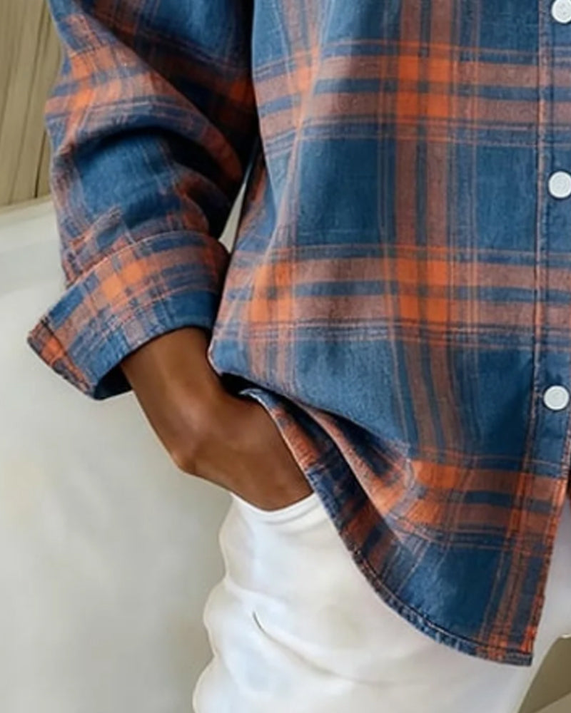 Plaid shirt sleeve detail in blue and orange with button-up placket