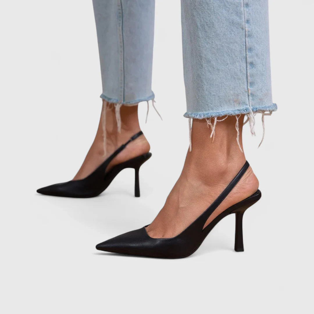 Black pointed-toe orthopedic pumps with mid-height block heel, angled side view