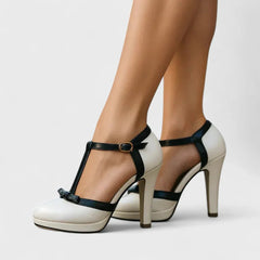 White platform Mary Jane heels with black ankle strap and round buckle