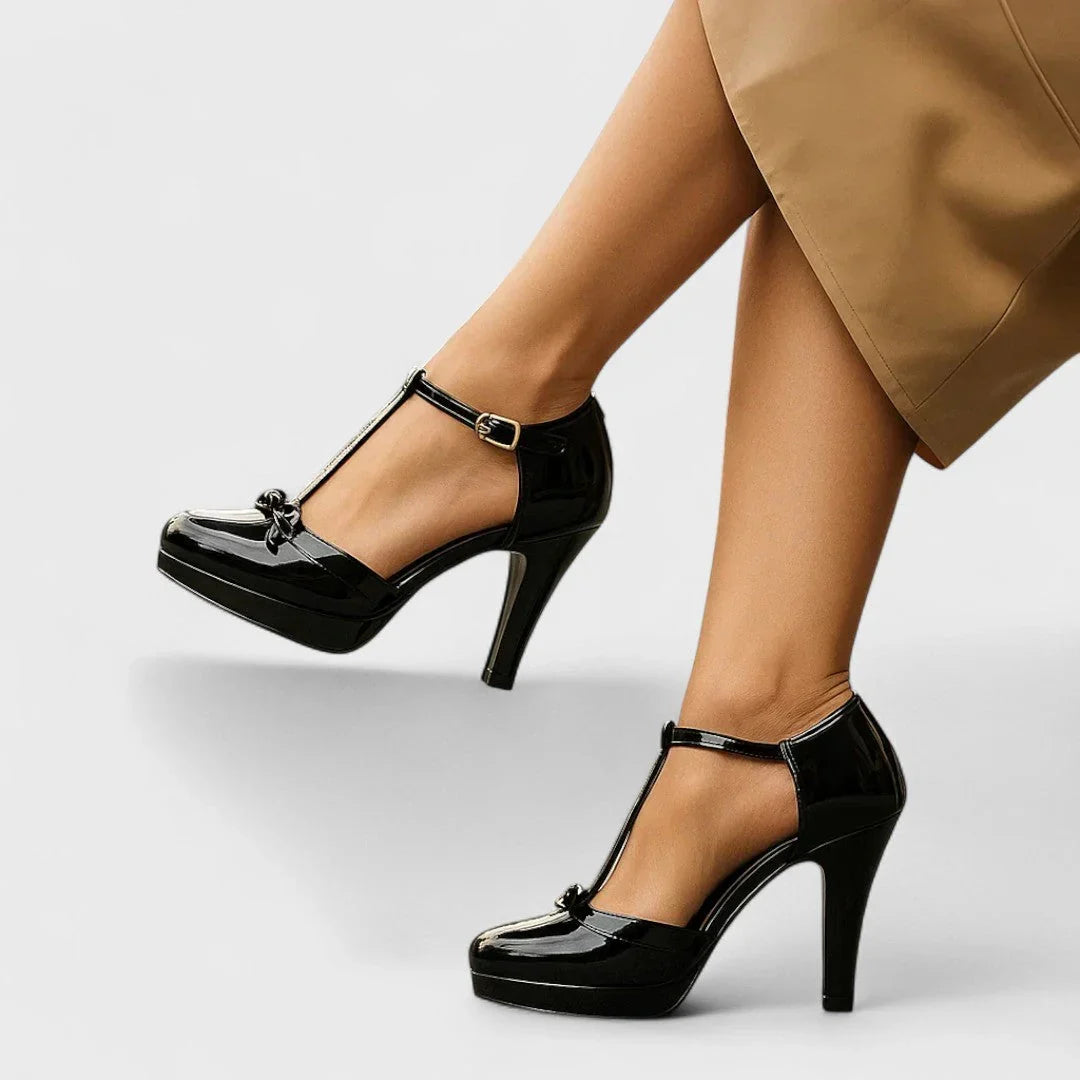 Black Mary Jane platform heels with ankle strap and small bow accent