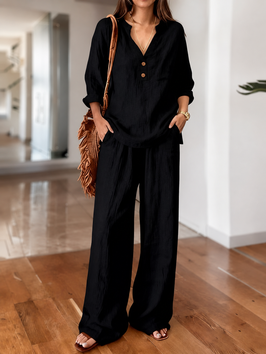 Black long-sleeve two-piece set with V-neck tunic top and wide-leg pants