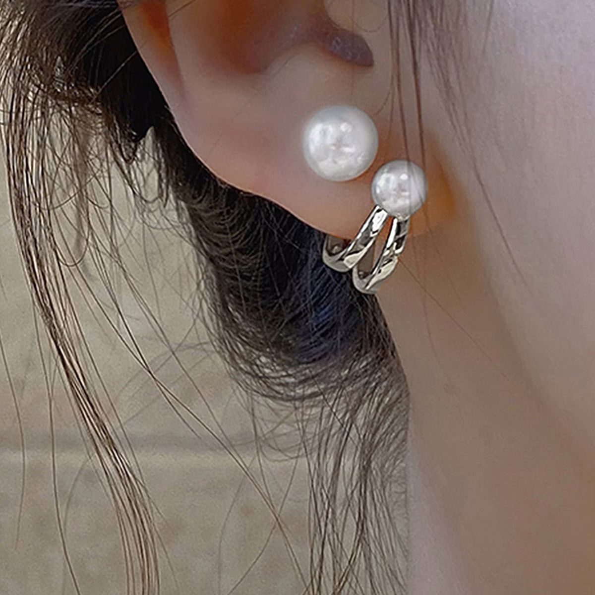 Twisted pearl statement earrings, silver-tone hoops with large white pearls on ear
