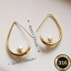 Gold crescent hoop earrings with white pearl, 1.18 in length.