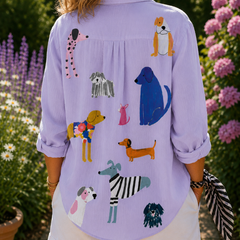 Lavender dog-print button-up blouse, back view with illustrated dogs and folded sleeves