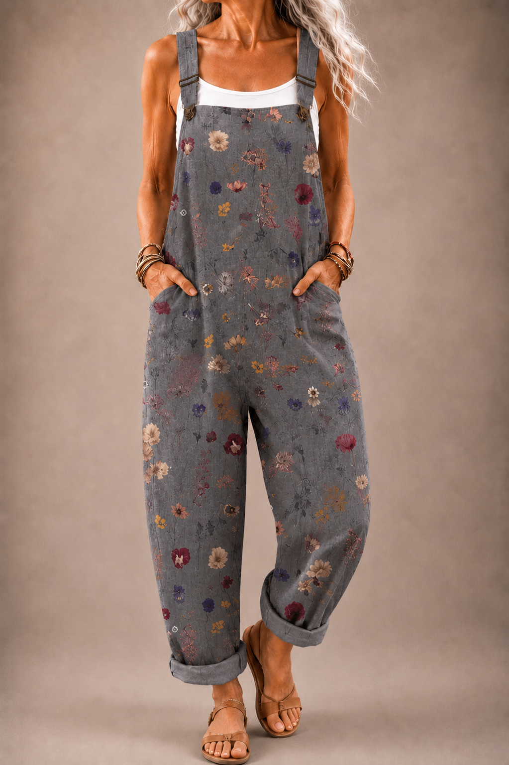Floral print gray sleeveless overalls with adjustable straps and front bib pocket