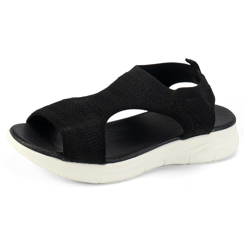 Black knit slip-on sandals with open toe and white cushioned sole