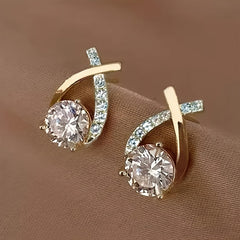 Gold-tone stud earrings with oval hoop frames and round crystal drop stones